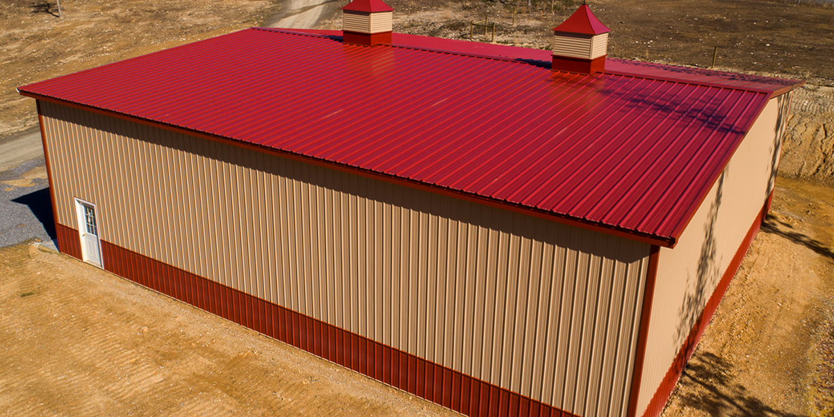 R-Loc red metal roof on a tan building